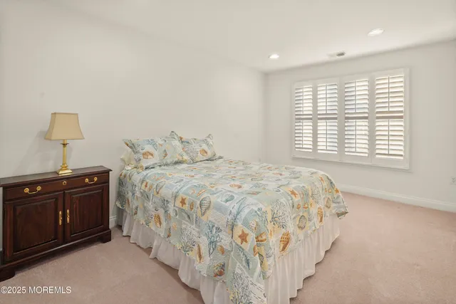 a bedroom with a bed and a lamp