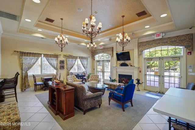 a living room with furniture a chandelier and a chandelier