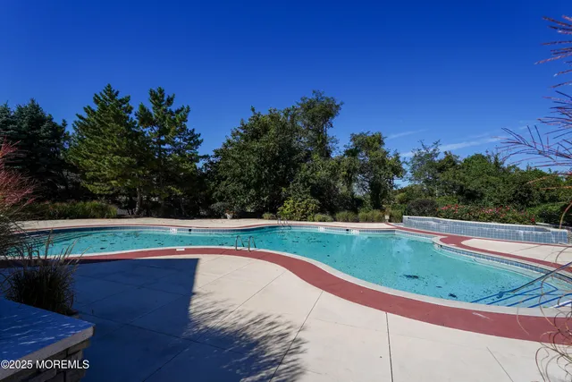 a view of a swimming pool with an outdoor space and seating area
