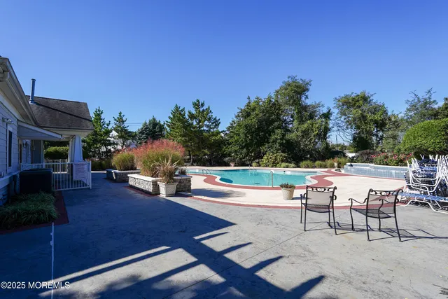 a swimming pool with outdoor seating and yard
