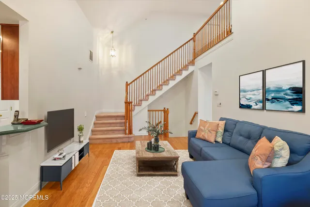 a living room with furniture and stairs