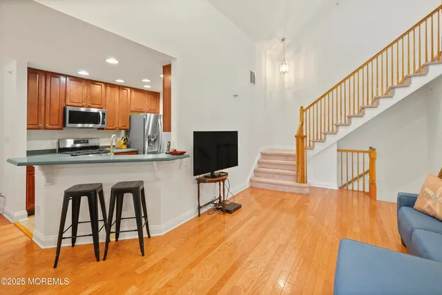 a dining room with furniture and a flat screen tv