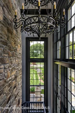 a spacious bedroom with a bed and a chandelier
