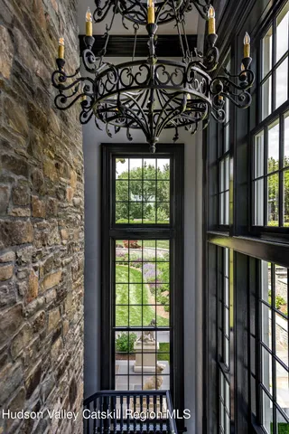 a spacious bedroom with a bed and a chandelier