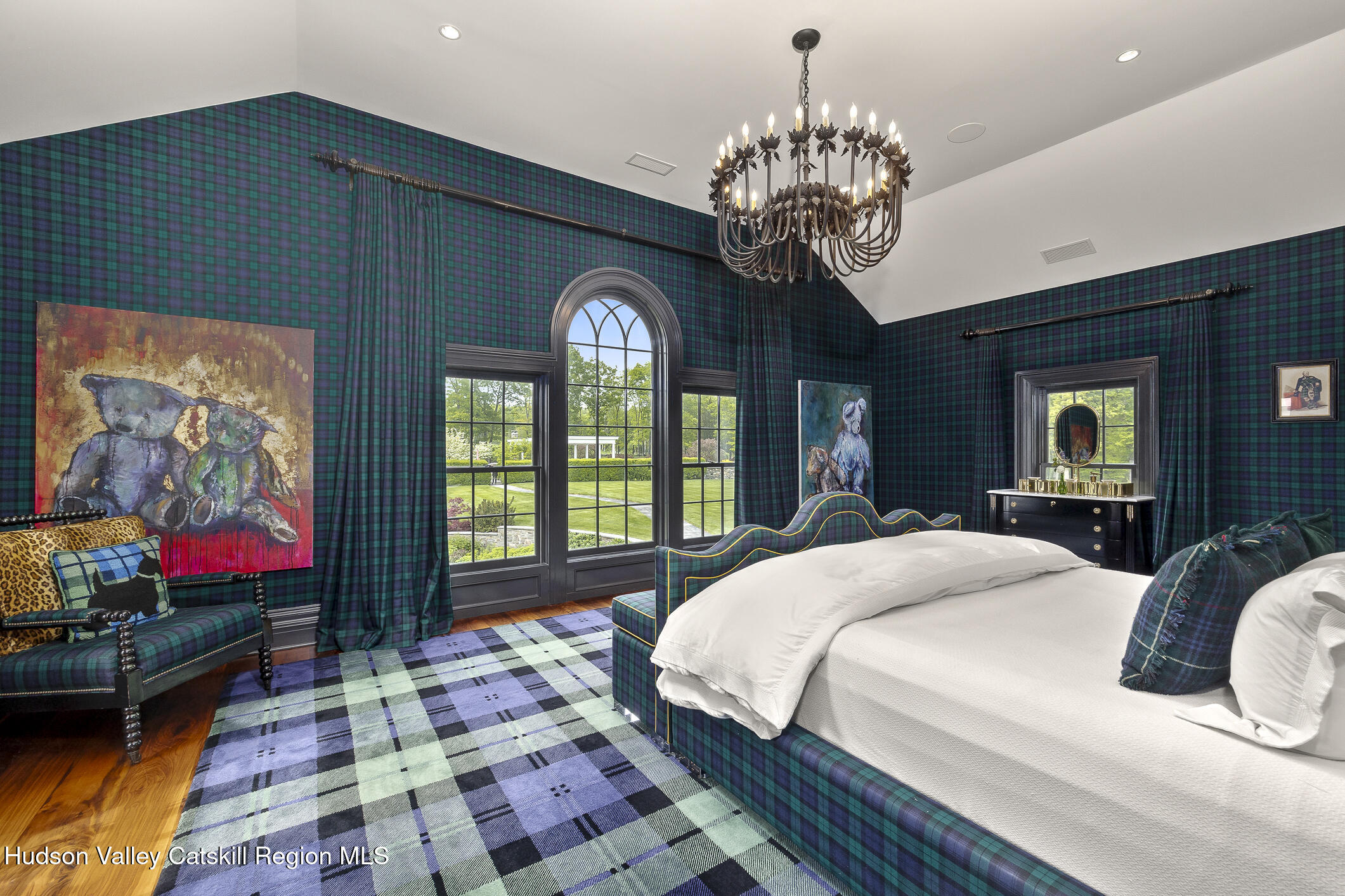 309 Woodstock Road Millbrook, NY 12545 - Photo 17 of 51 a spacious bedroom with a bed and a chandelier