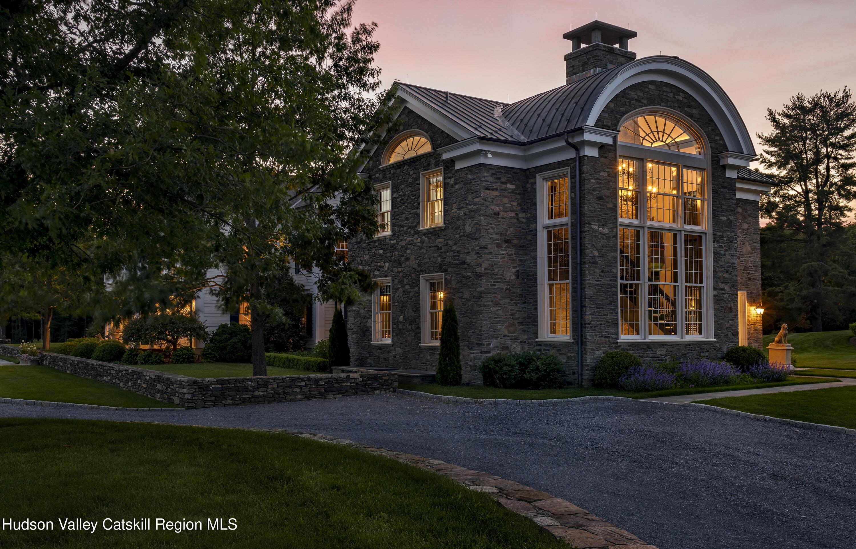 309 Woodstock Road Millbrook, NY 12545 - Photo 22 of 51 a front view of a house with garden