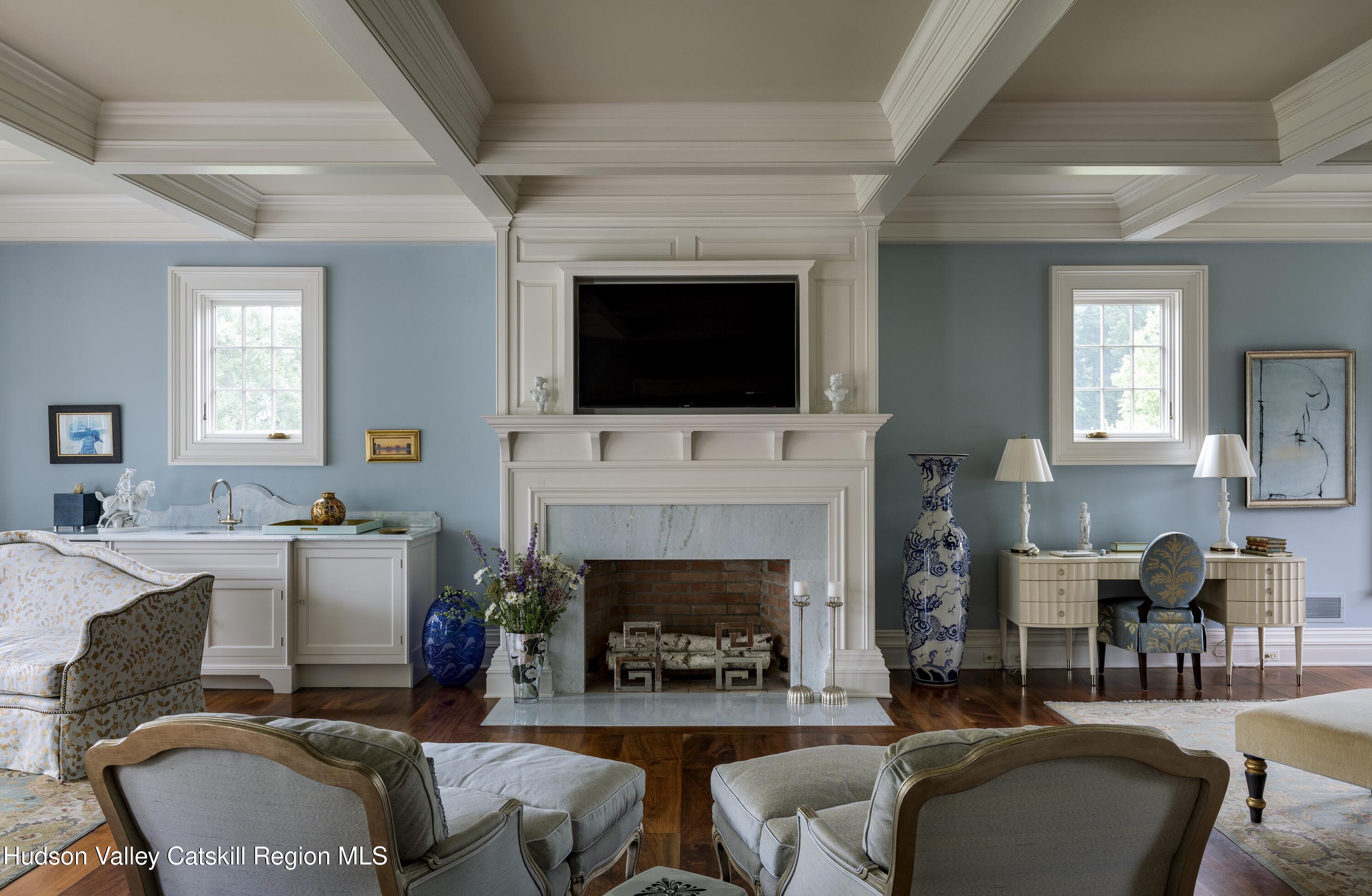 309 Woodstock Road Millbrook, NY 12545 - Photo 23 of 51 a living room with furniture a fireplace and a flat screen tv