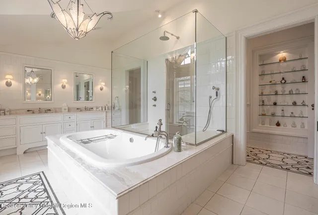 a white bed sitting in a room next to a window