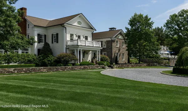 a front view of a house with lots of green space