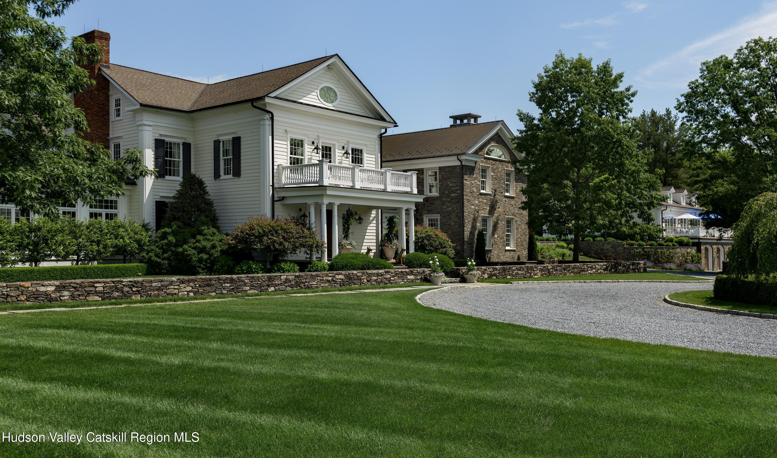 309 Woodstock Road Millbrook, NY 12545 - Photo 3 of 51 a front view of a house with a yard