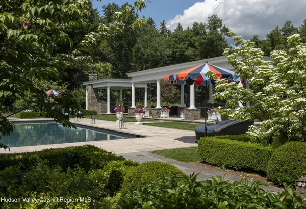a view of a patio with couches table and chairs with garden view