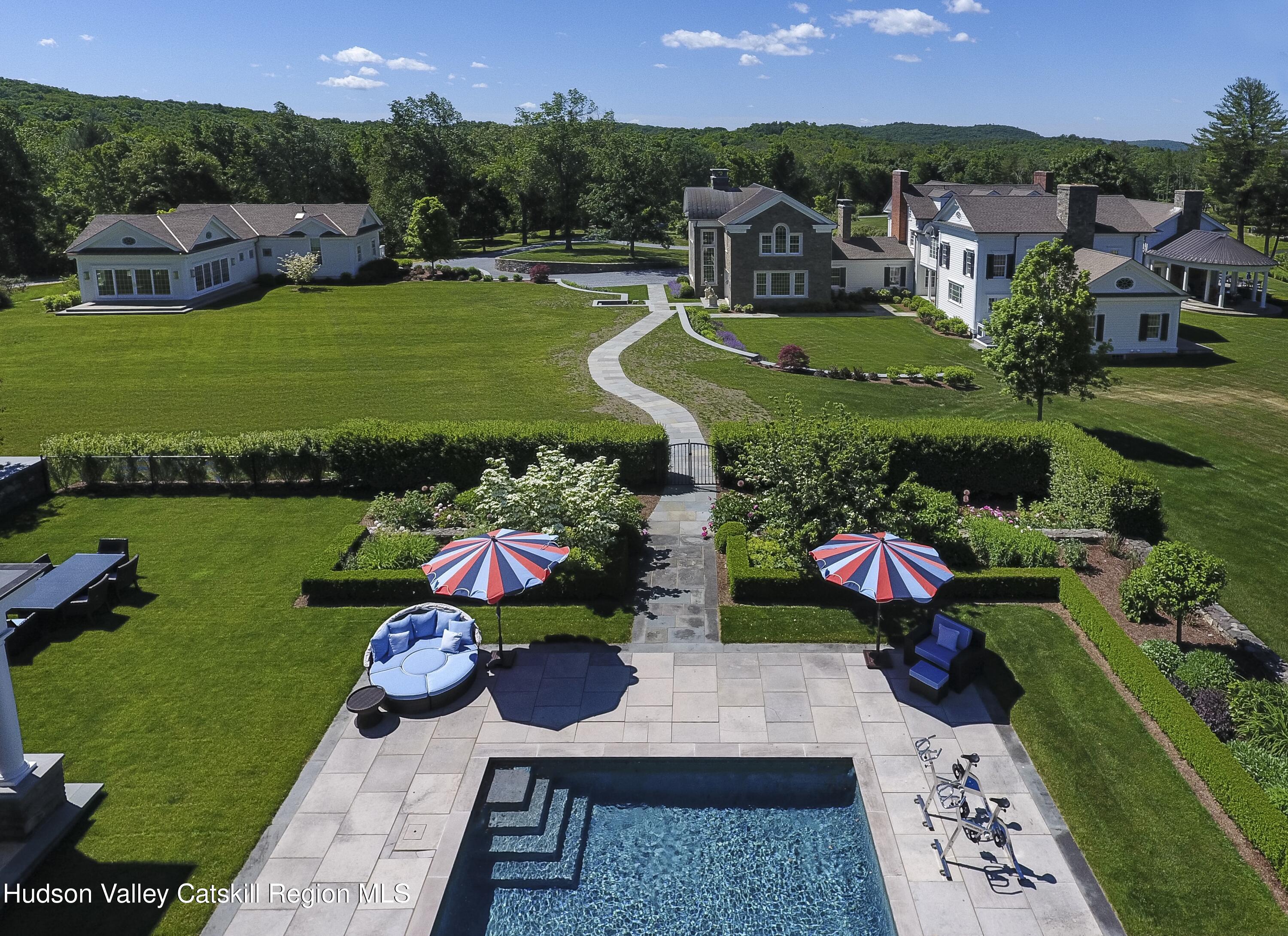 309 Woodstock Road Millbrook, NY 12545 - Photo 32 of 51 swimming pool view with a seating space and a garden