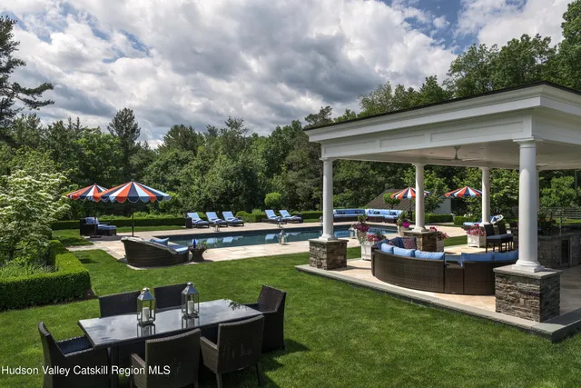 a view of swimming pool with outdoor seating and plants