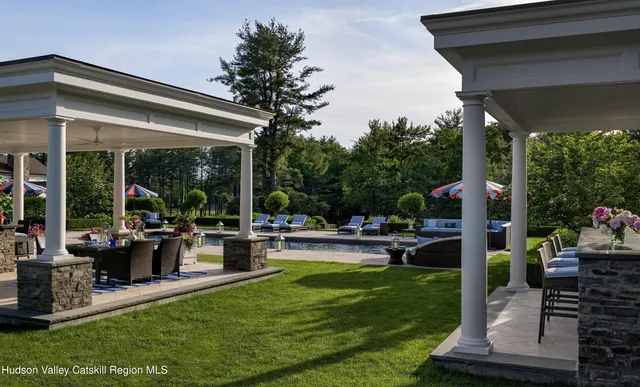 a front view of a house with a yard and trees