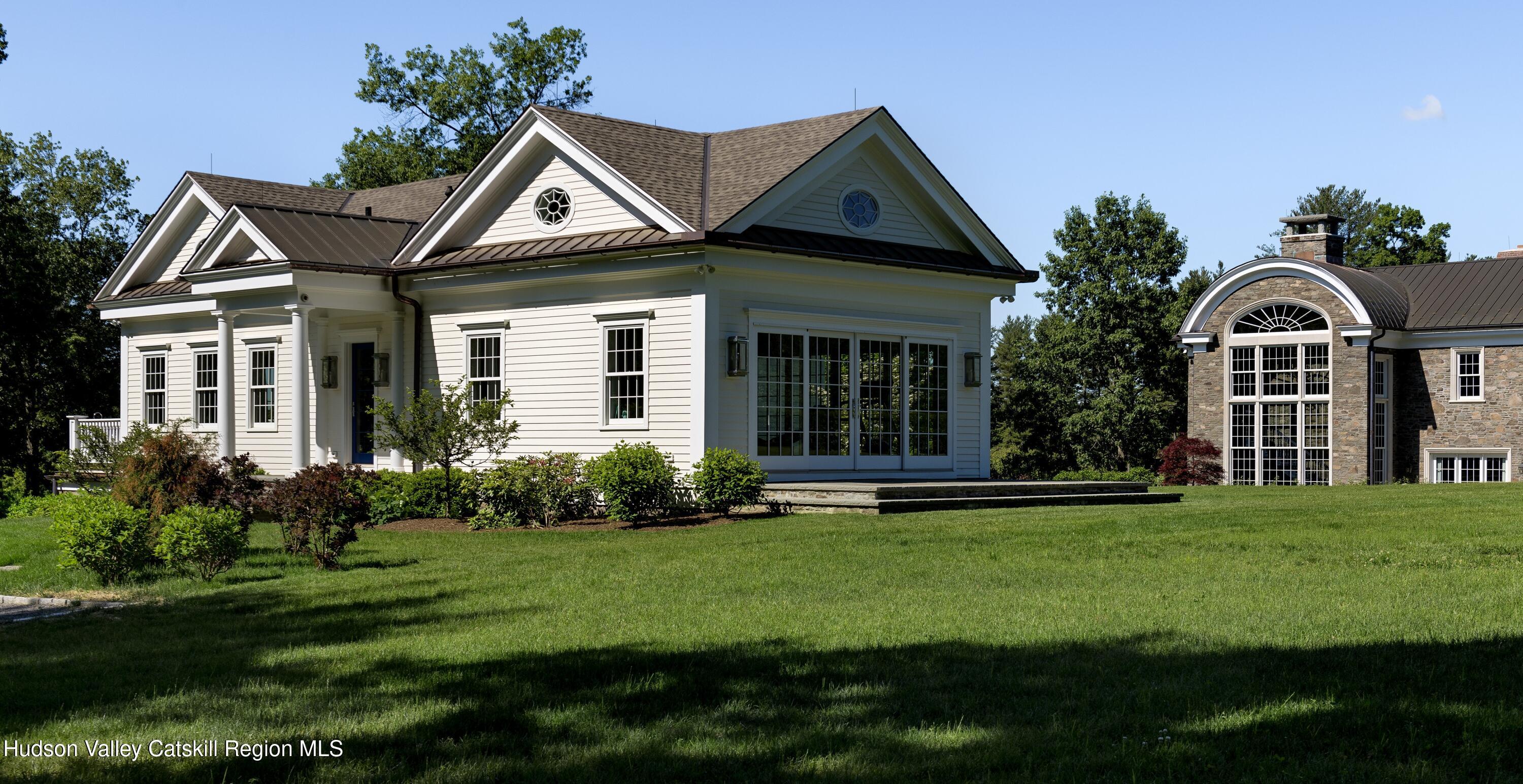 309 Woodstock Road Millbrook, NY 12545 - Photo 38 of 51 a front view of a house with a yard and trees