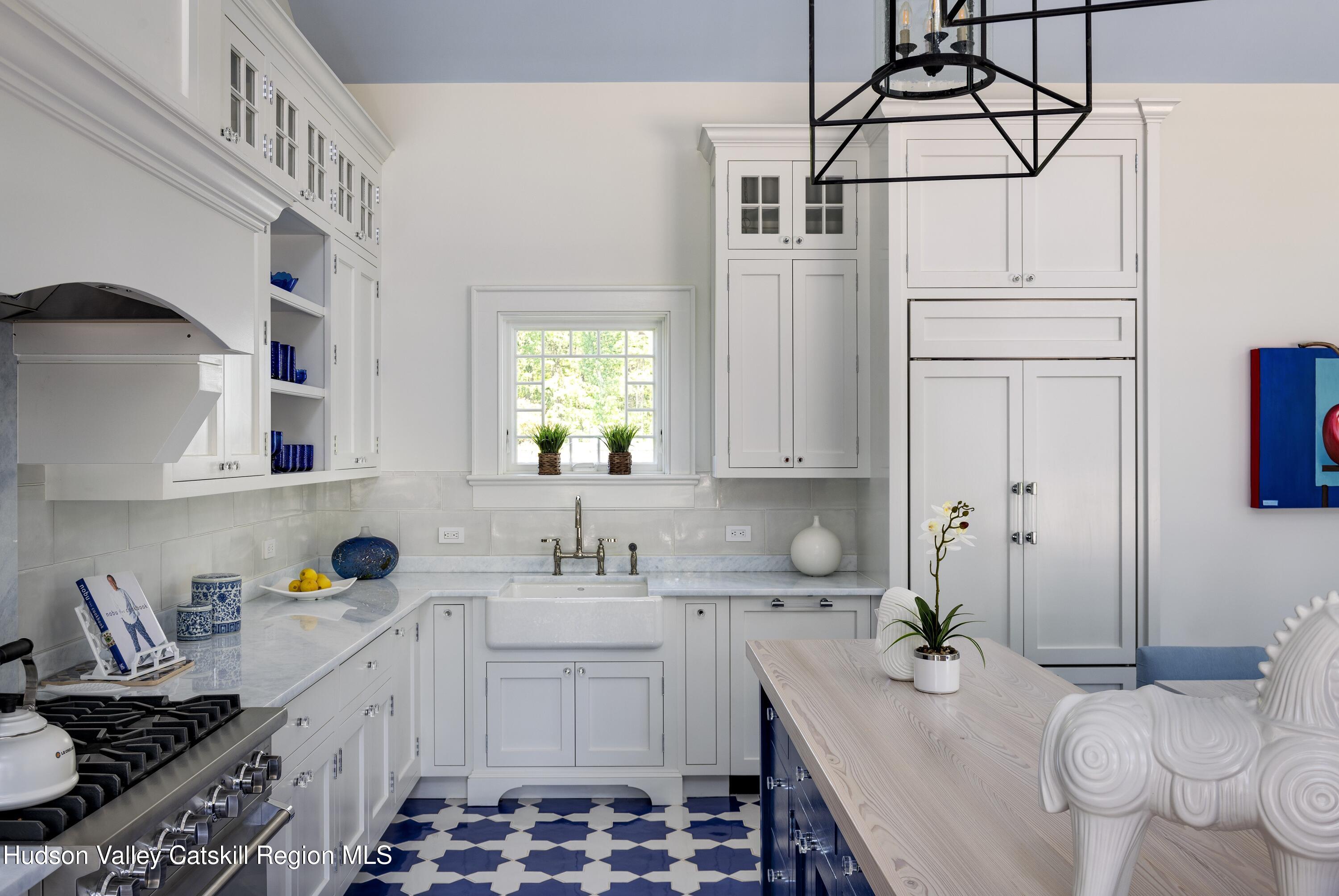 309 Woodstock Road Millbrook, NY 12545 - Photo 40 of 51 a kitchen with a sink stove and cabinets