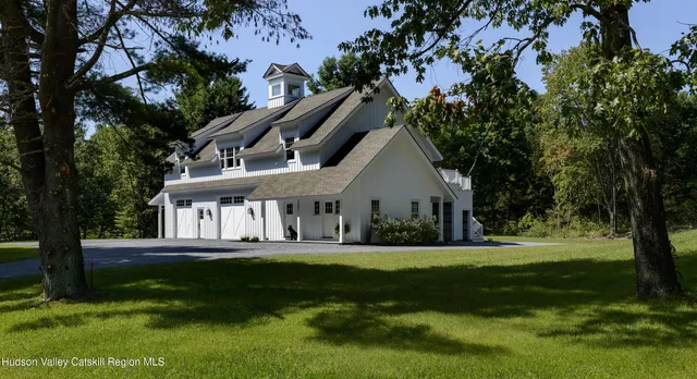 a kitchen with stainless steel appliances granite countertop a sink a stove and wooden floors
