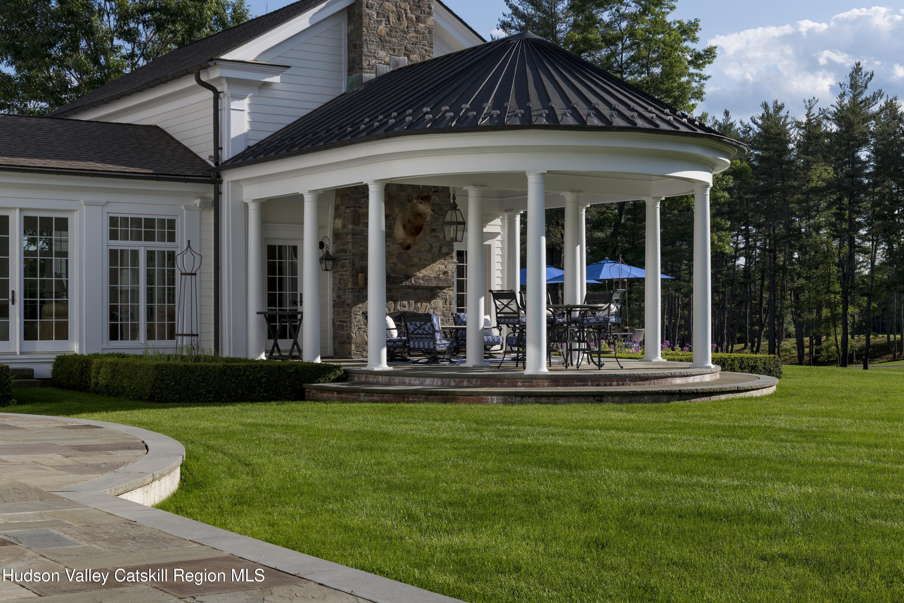 309 Woodstock Road Millbrook, NY 12545 - Photo 9 of 51 a front view of a house with a yard