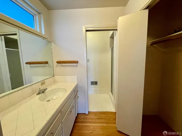 a bathroom with a tub shower and sink