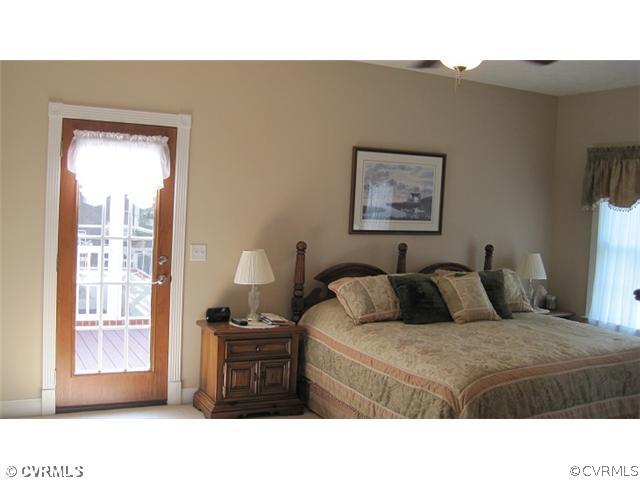 11928 Winterpock Road Chesterfield, VA 23838 - Photo 8 of 12 a bedroom with a bed and a window