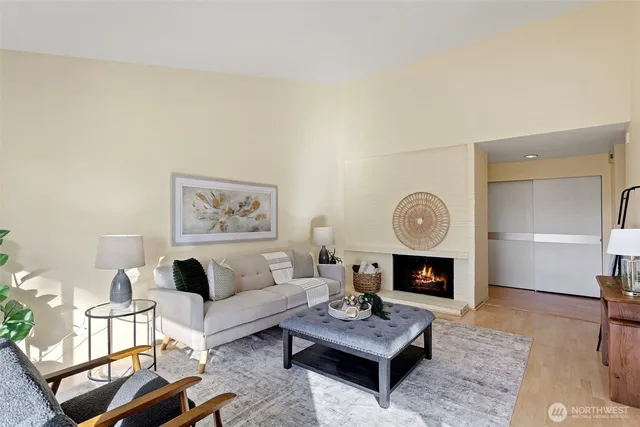 a living room with furniture a fireplace and a table