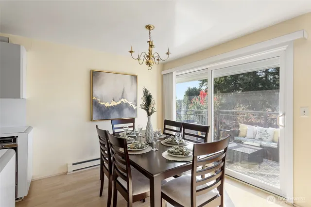 a view of a dining room with furniture a chandelier and wooden floor