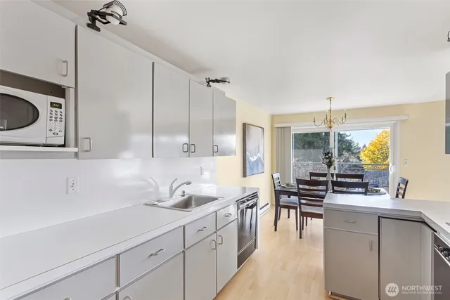 a kitchen with stainless steel appliances a sink stove and cabinets