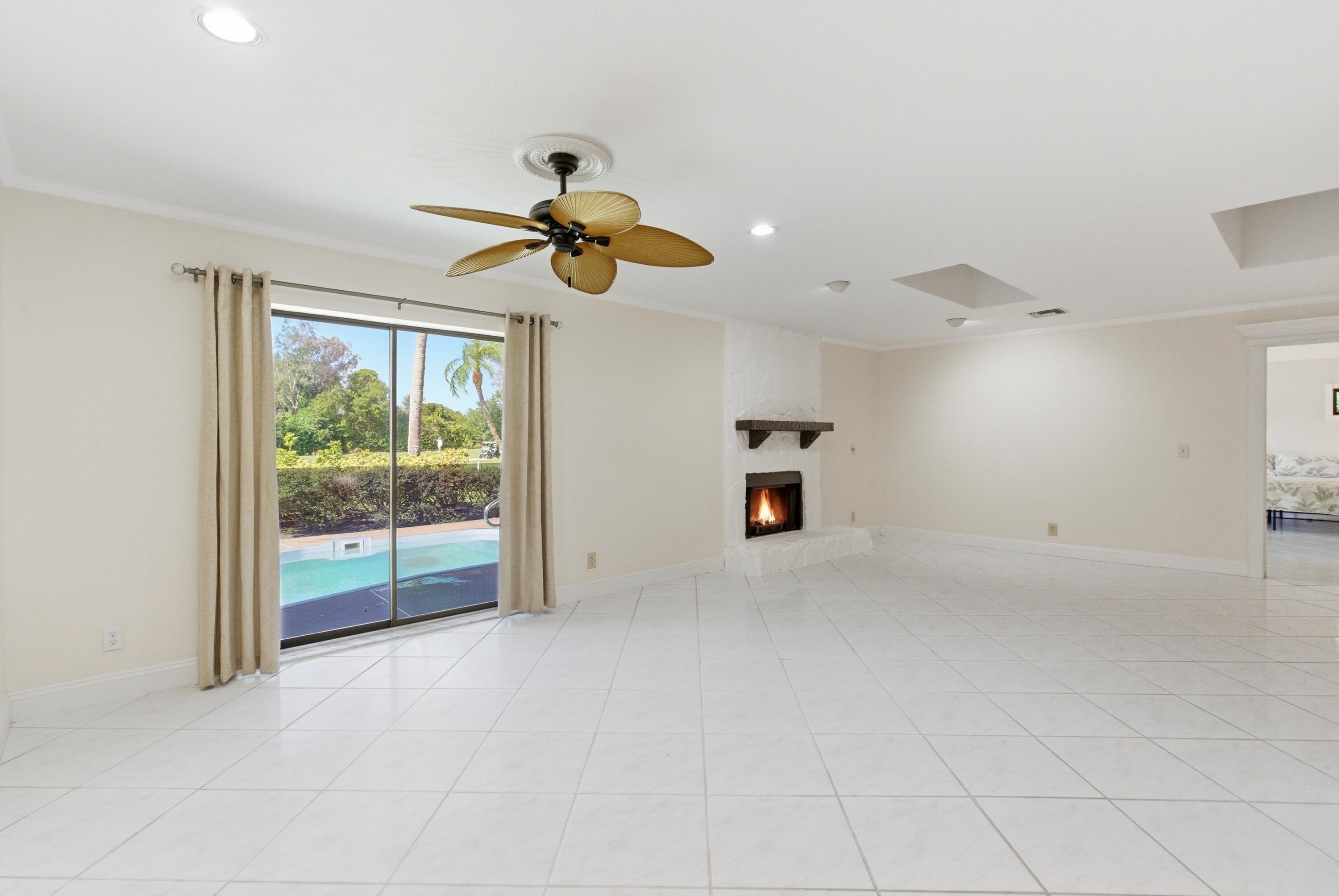 5151 Southeast Burning Tree Circle Stuart, FL 34997 - Photo 16 of 74 an empty room with windows and ceiling fan