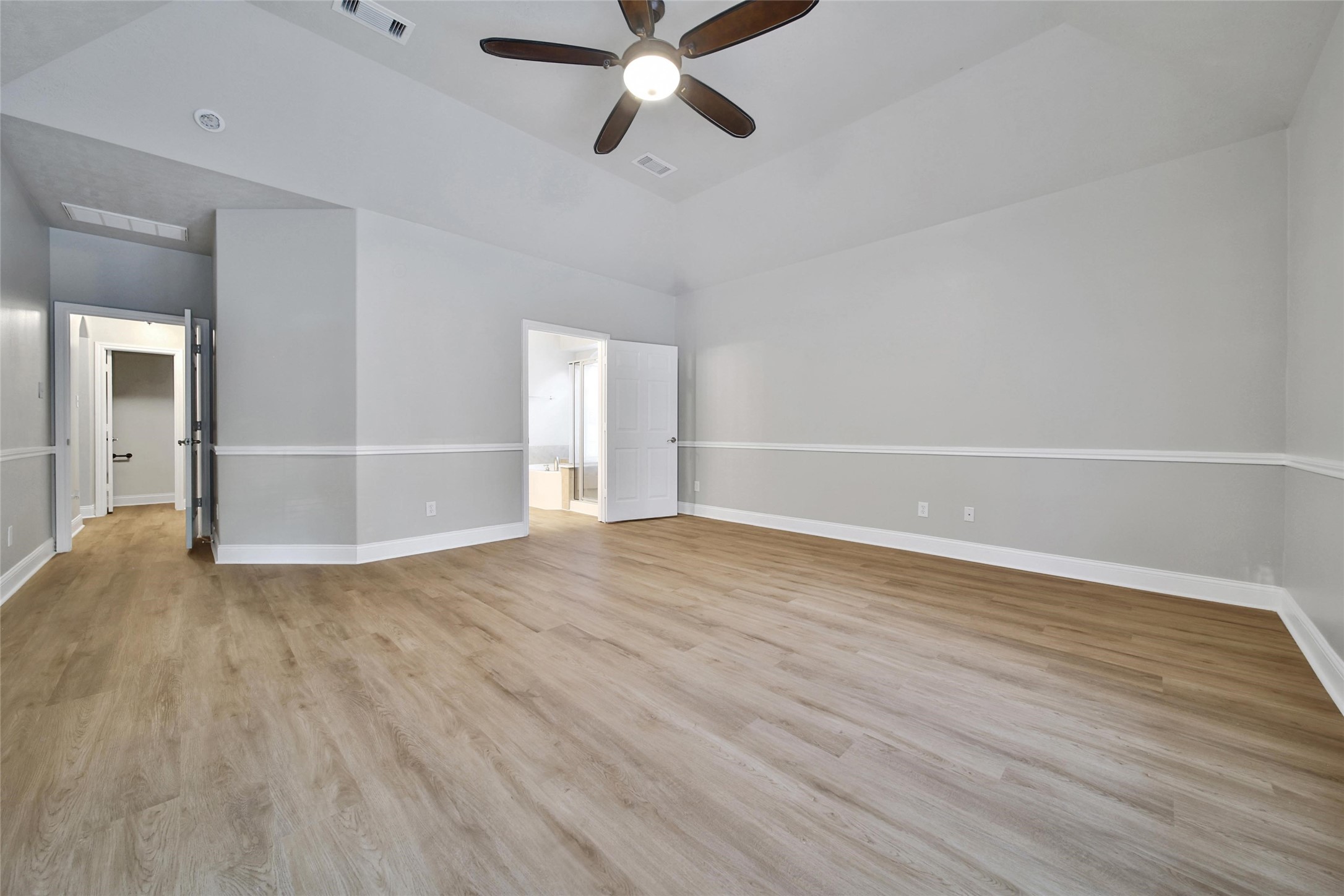 2315 Legends Gate Drive Spring, TX 77386 - Photo 18 of 50 an empty room with wooden floor a ceiling fan and windows