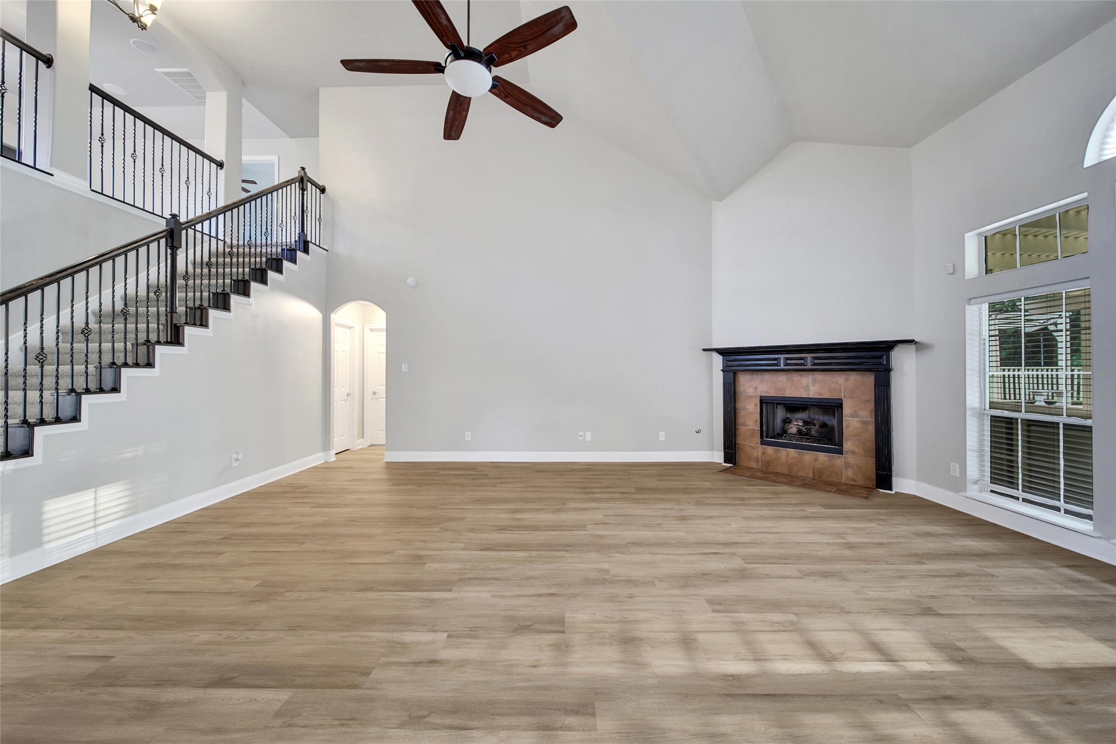 2315 Legends Gate Drive Spring, TX 77386 - Photo 6 of 50 a view of an empty room with wooden floor and a fireplace