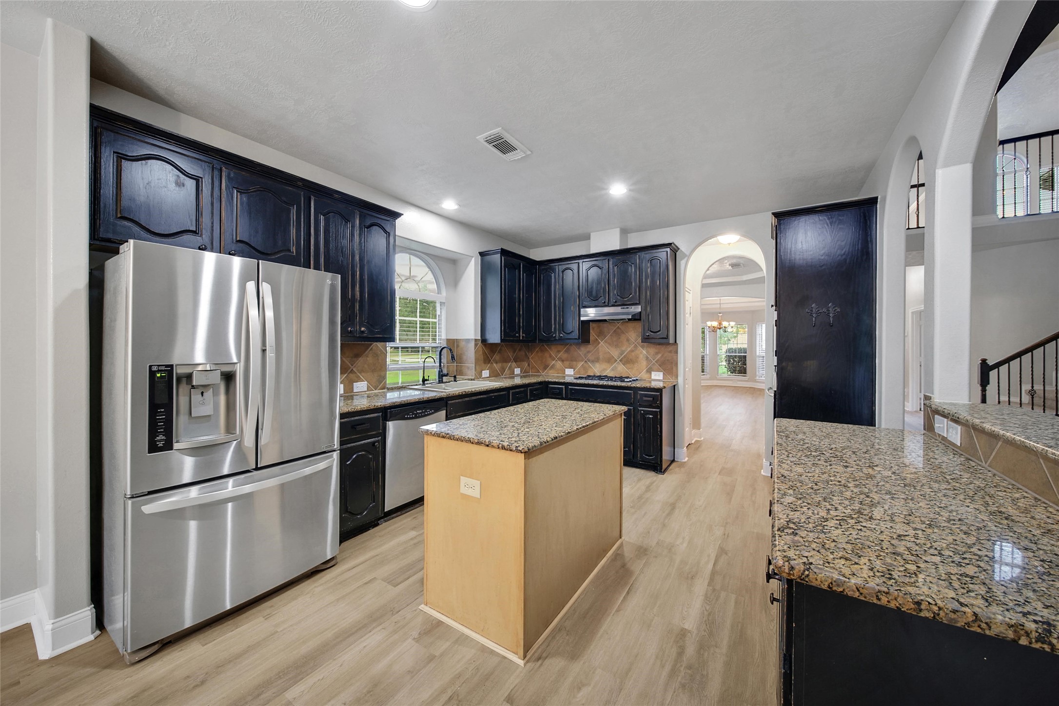 2315 Legends Gate Drive Spring, TX 77386 - Photo 8 of 50 a kitchen with stainless steel appliances granite countertop a refrigerator a stove and a sink
