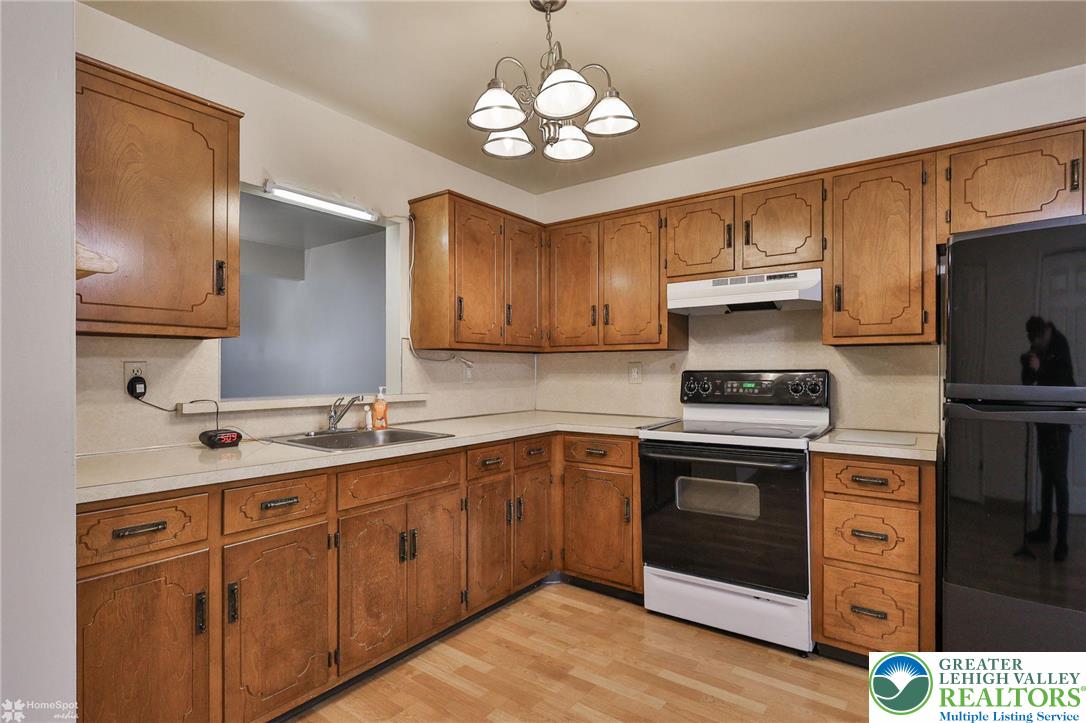 822 Elm Street Bethlehem, PA 18018 - Photo 14 of 40 a kitchen with cabinets stainless steel appliances a sink and wooden floor