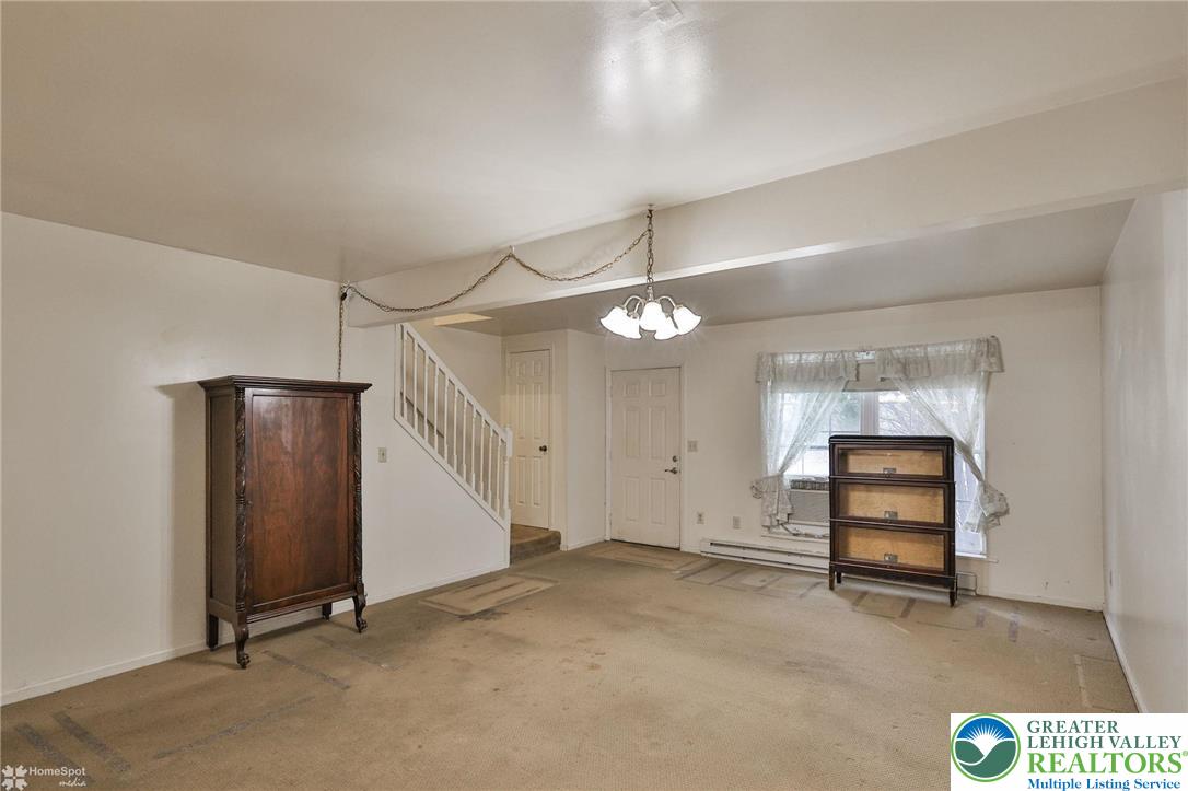 822 Elm Street Bethlehem, PA 18018 - Photo 6 of 40 an empty room with chandelier fan and windows