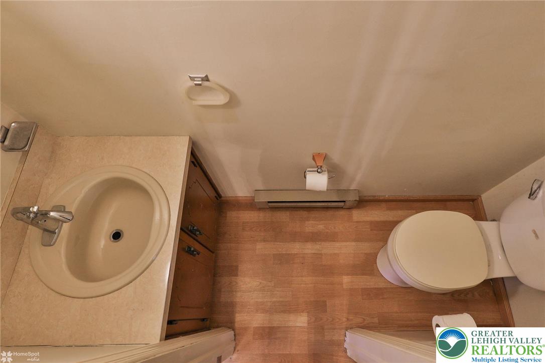 822 Elm Street Bethlehem, PA 18018 - Photo 8 of 40 a bathroom with a sink a mirror and a shower