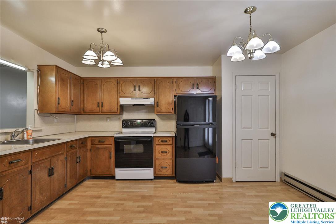 822 Elm Street Bethlehem, PA 18018 - Photo 10 of 40 a kitchen with stainless steel appliances granite countertop a refrigerator a sink dishwasher a stove and white cabinets with wooden floor