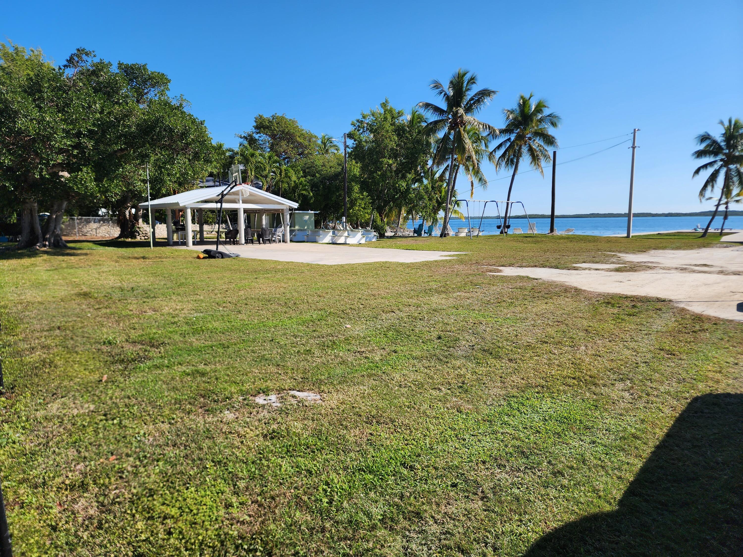 62 Southeast Marlin Avenue Key Largo, FL 33037 - Photo 11 of 14 a front view of a house with a yard