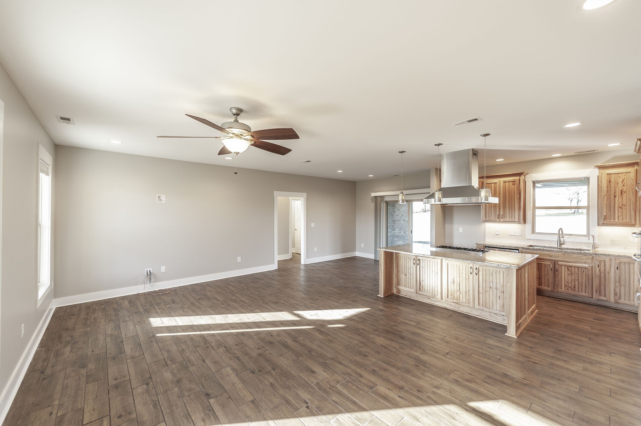 7728 Boyles Road White House, TN 37188 - Photo 18 of 60 a view of a kitchen with kitchen island a sink wooden floor and stainless steel appliances