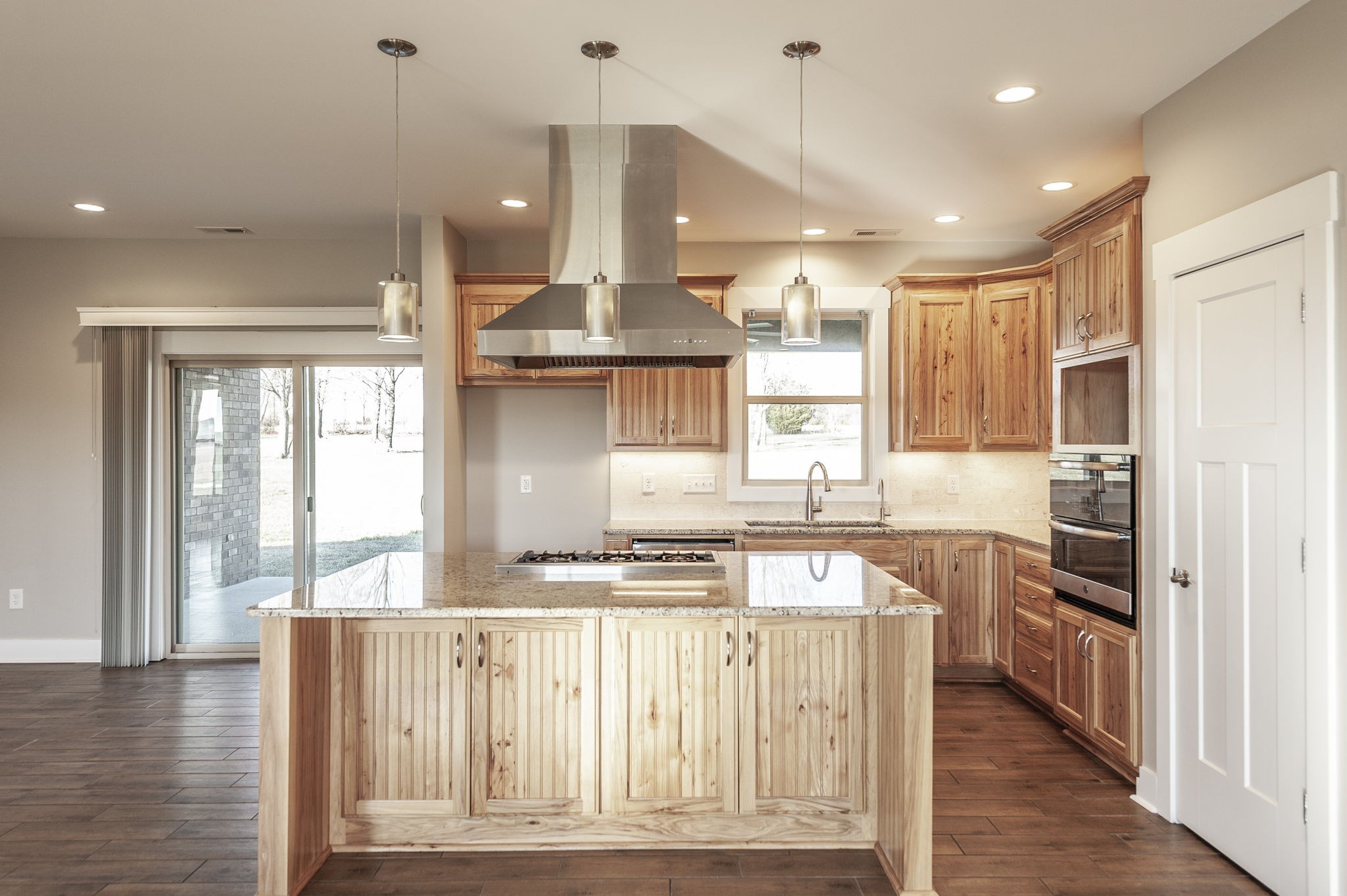 7728 Boyles Road White House, TN 37188 - Photo 23 of 60 a kitchen with stainless steel appliances granite countertop a refrigerator a sink dishwasher a stove and white cabinets with wooden floor