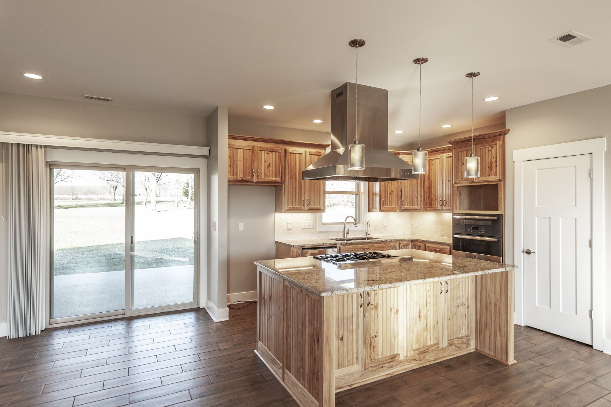 7728 Boyles Road White House, TN 37188 - Photo 24 of 60 a kitchen with stainless steel appliances granite countertop a stove a refrigerator and a view of living room