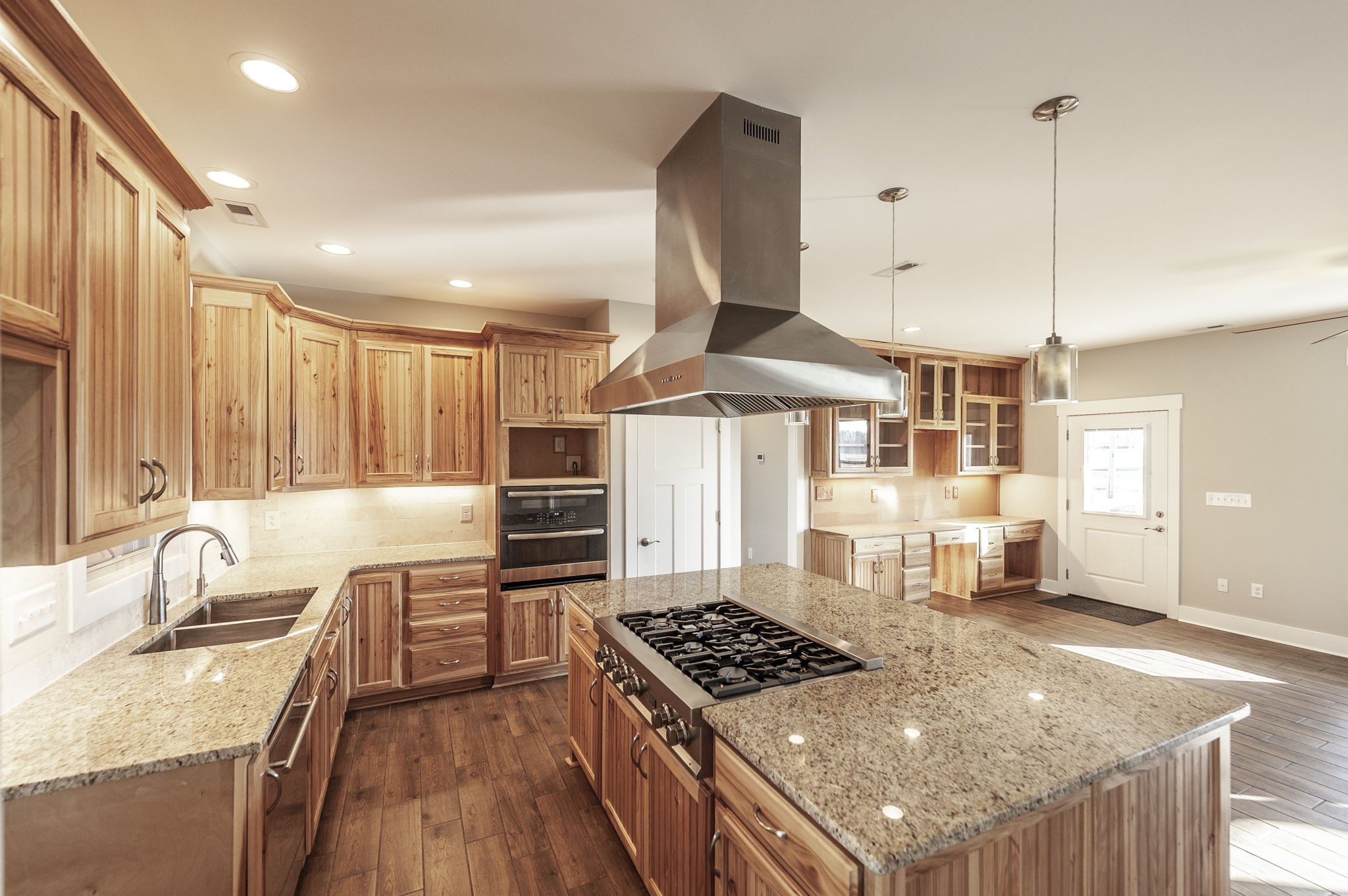 7728 Boyles Road White House, TN 37188 - Photo 26 of 60 a kitchen with stainless steel appliances granite countertop a stove a sink and a wooden cabinets