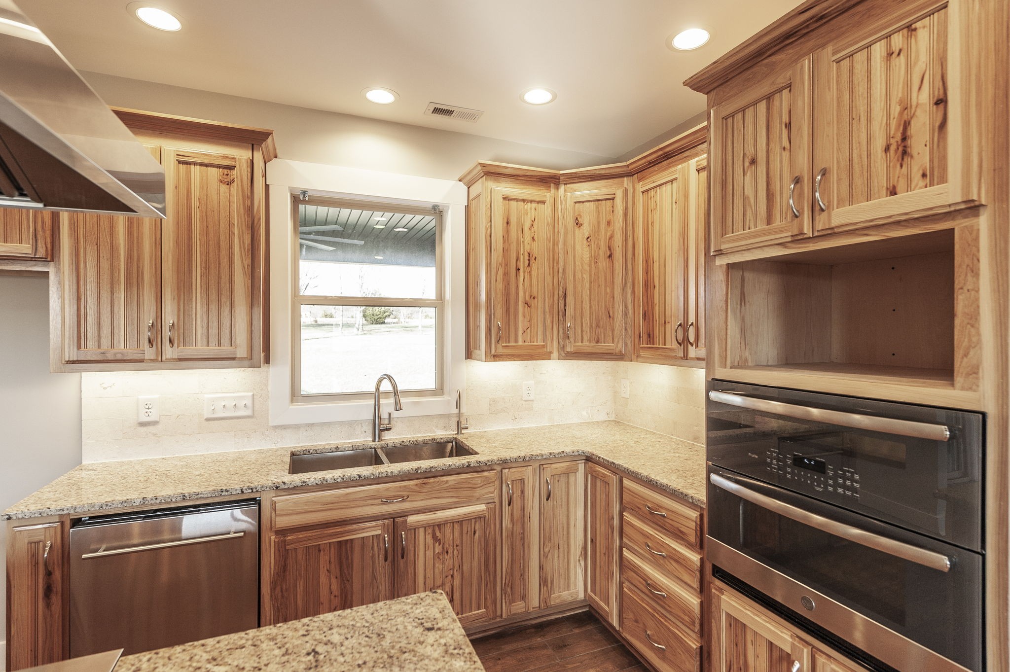 7728 Boyles Road White House, TN 37188 - Photo 27 of 60 a kitchen with stainless steel appliances granite countertop a sink stove and refrigerator