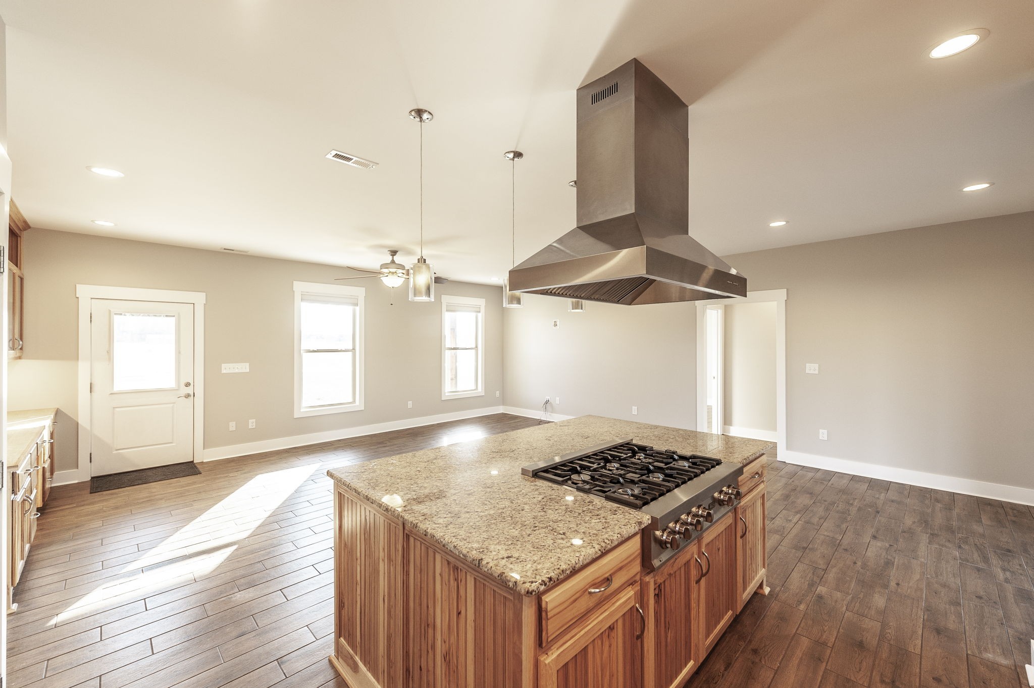 7728 Boyles Road White House, TN 37188 - Photo 31 of 60 an open kitchen stove sink and cabinets with wooden floor
