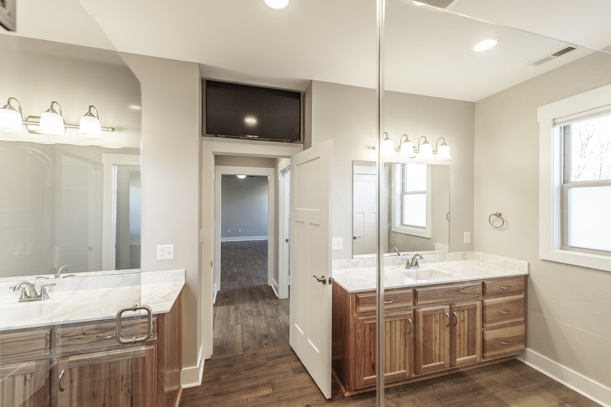 7728 Boyles Road White House, TN 37188 - Photo 43 of 60 a spacious bathroom with a double vanity sink a large mirror and a bathtub