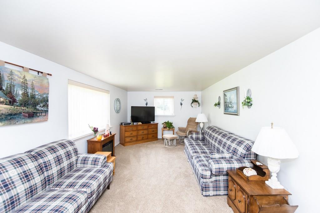 949 Lyn Road Sarver, PA 16055 - Photo 12 of 25 The large living room features carpeting with hardwood floors extending underneath. The 2 windows facilitate an abundance of natural light.