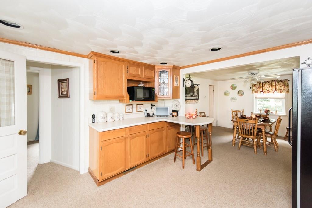949 Lyn Road Sarver, PA 16055 - Photo 7 of 25 Alternate view from the kitchen into the dining room. In addition to dining room seating, there is seating for 2 at the L-shaped kitchen counter. The open space creates a great flow. The recessed lighting creates lots of light. The doorway through the hall to the left is the master bedroom.
