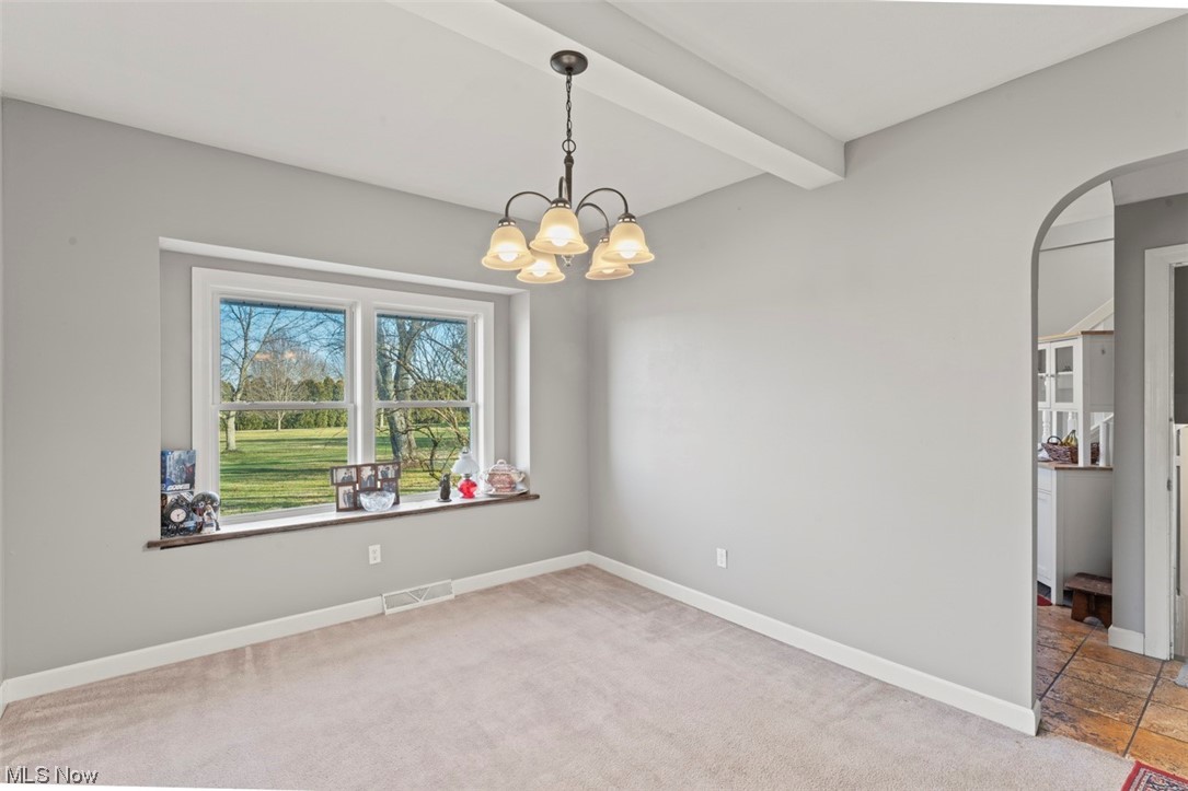 4275 West Calla Road Canfield, OH 44406 - Photo 10 of 31 Spare room with light carpet, beamed ceiling, and a notable chandelier