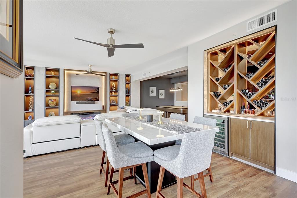 610 Riviera Dunes Way, Unit 602 Palmetto, FL 34221 - Photo 16 of 79 a view of a dining room with furniture and a flat screen tv