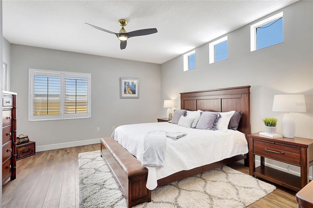 610 Riviera Dunes Way, Unit 602 Palmetto, FL 34221 - Photo 30 of 79 a bedroom with a bed a dresser and a window