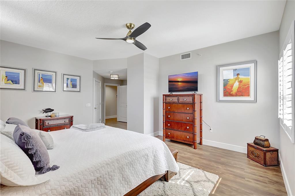 610 Riviera Dunes Way, Unit 602 Palmetto, FL 34221 - Photo 31 of 79 a bedroom with a bed and wooden floor