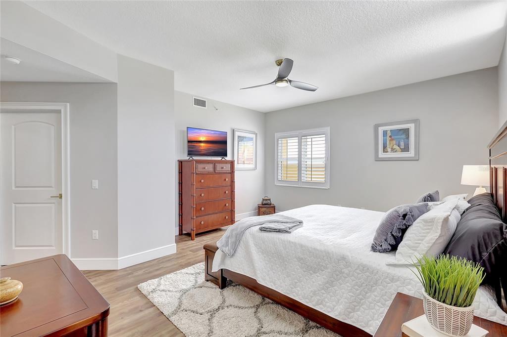 610 Riviera Dunes Way, Unit 602 Palmetto, FL 34221 - Photo 32 of 79 a bedroom with a bed and wooden floor